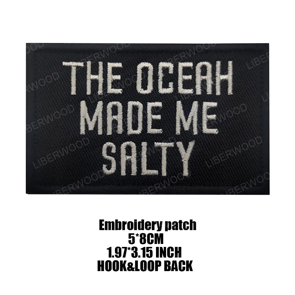 Black embroidered patch with white text that reads The Ocean Made Me Salty
