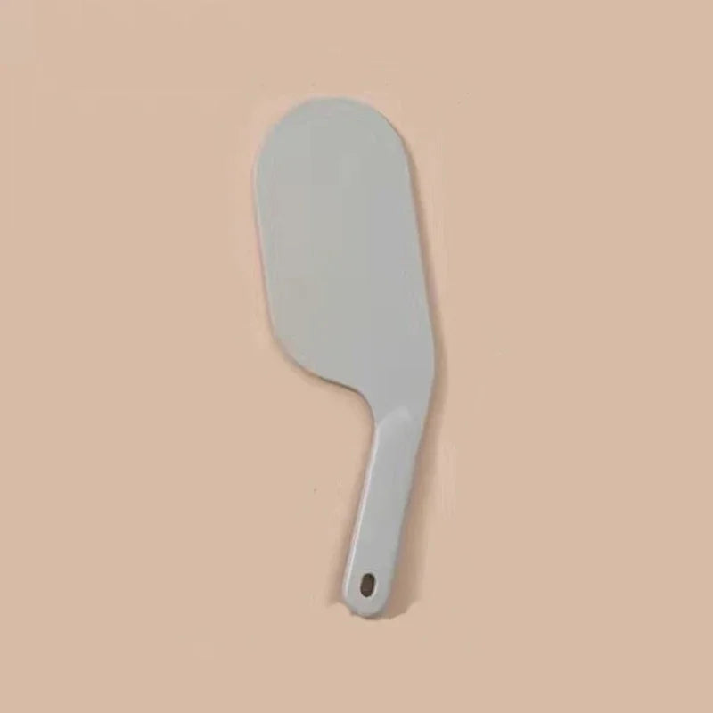 A white bed sheet folding and organizing tool with a curved blade and handle.