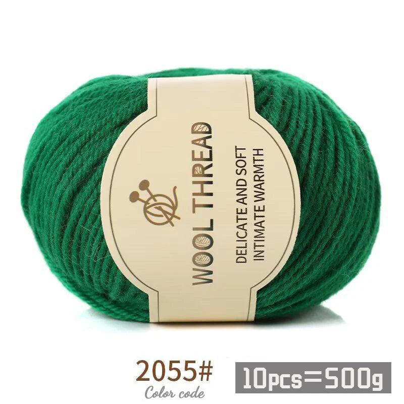 A ball of green wool thread labeled as delicate and soft intimate warmth yarn for knitting.