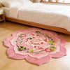 A round rug featuring a pink background with colorful koi fish and floral patterns on a light wooden floor.