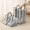 A set of clear mesh portable boot storage bags with black handles resting on a light-colored carpet.
