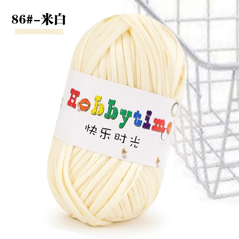 A ball of light yellow craft yarn labeled Hobbytime for knitting and crochet