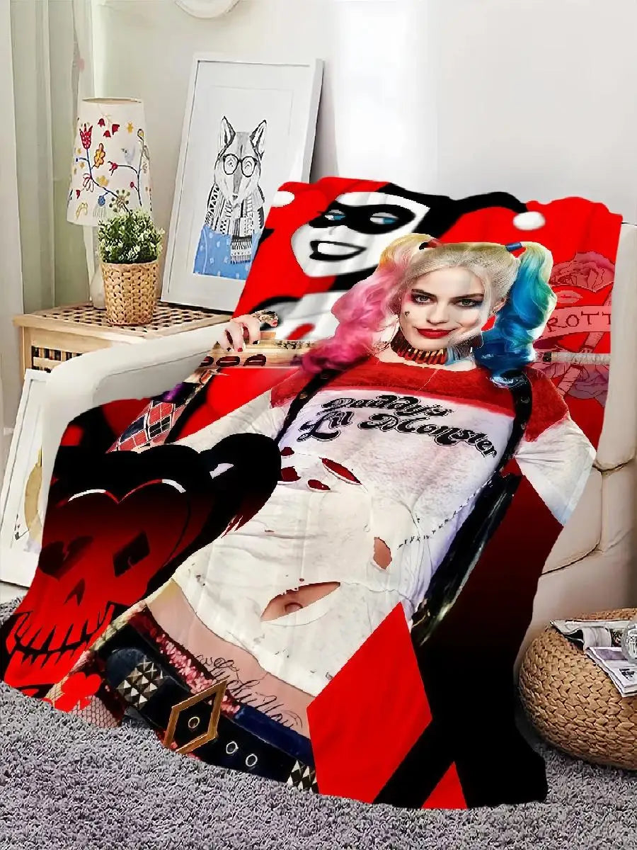 A woman with pink hair and makeup is featured on a red flannel throw blanket design.