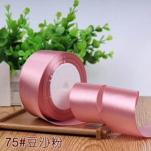 Roll of pink satin ribbon for gift wrapping and DIY crafts