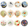 A collection of colorful floral cross stitch embroidery designs on circular fabric pieces.