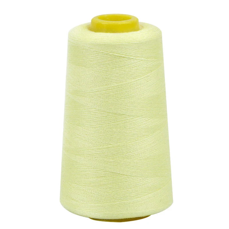 A roll of light yellow sewing thread on a spool.