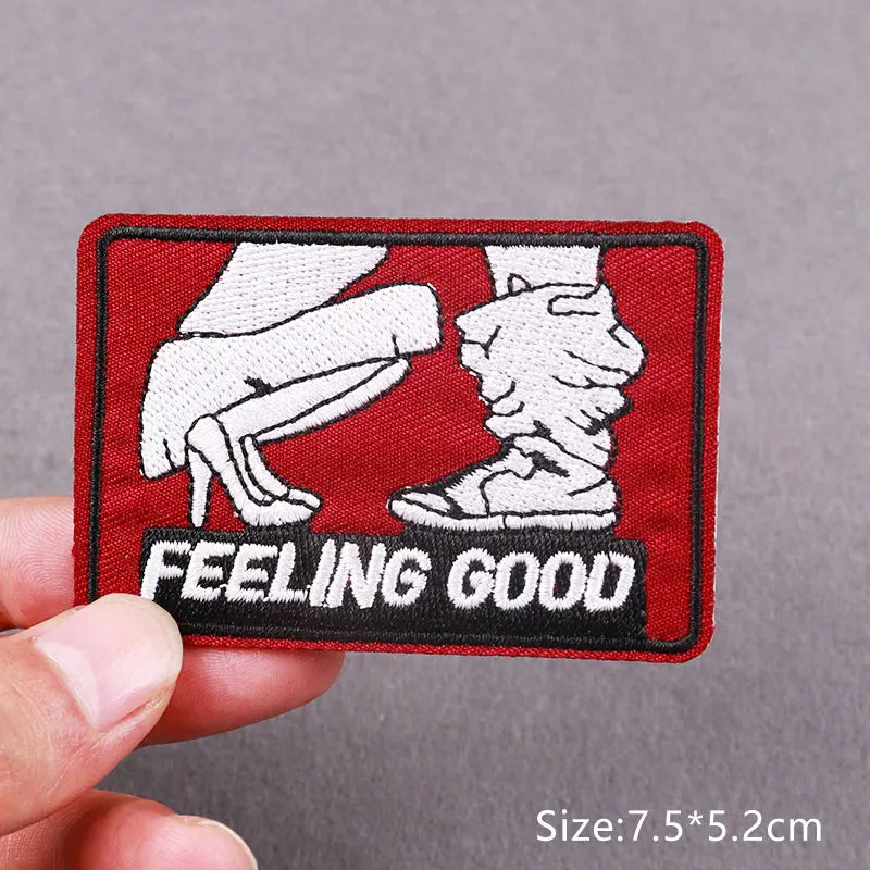 Red embroidered patch with white silhouette of a hand and foot and the text FEELING GOOD