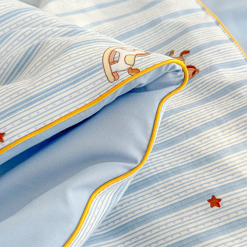 Light blue striped quilt fabric with a cartoon animal design and a star detail.