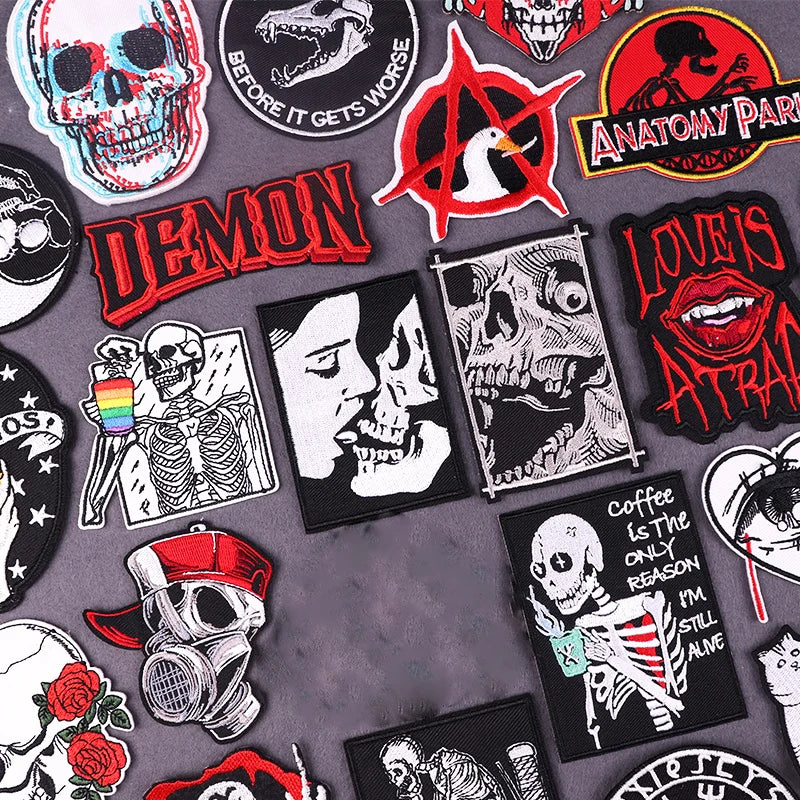 A collection of dark, gothic, and anatomical themed embroidered patches featuring skulls, demons, and stylized faces.
