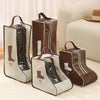 A set of brown and beige portable boot storage bags with carry handles displayed on a light rug.