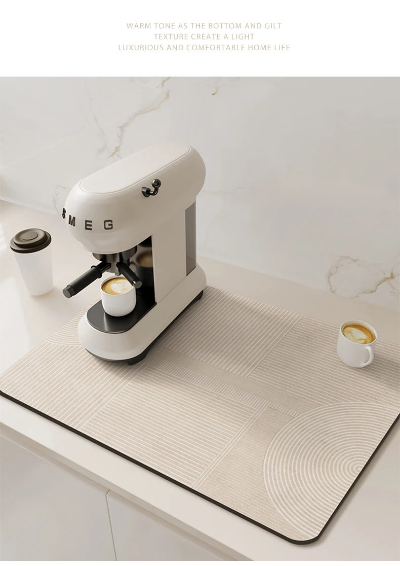 A white Mego espresso machine is placed on a beige kitchen drain mat on a white countertop.