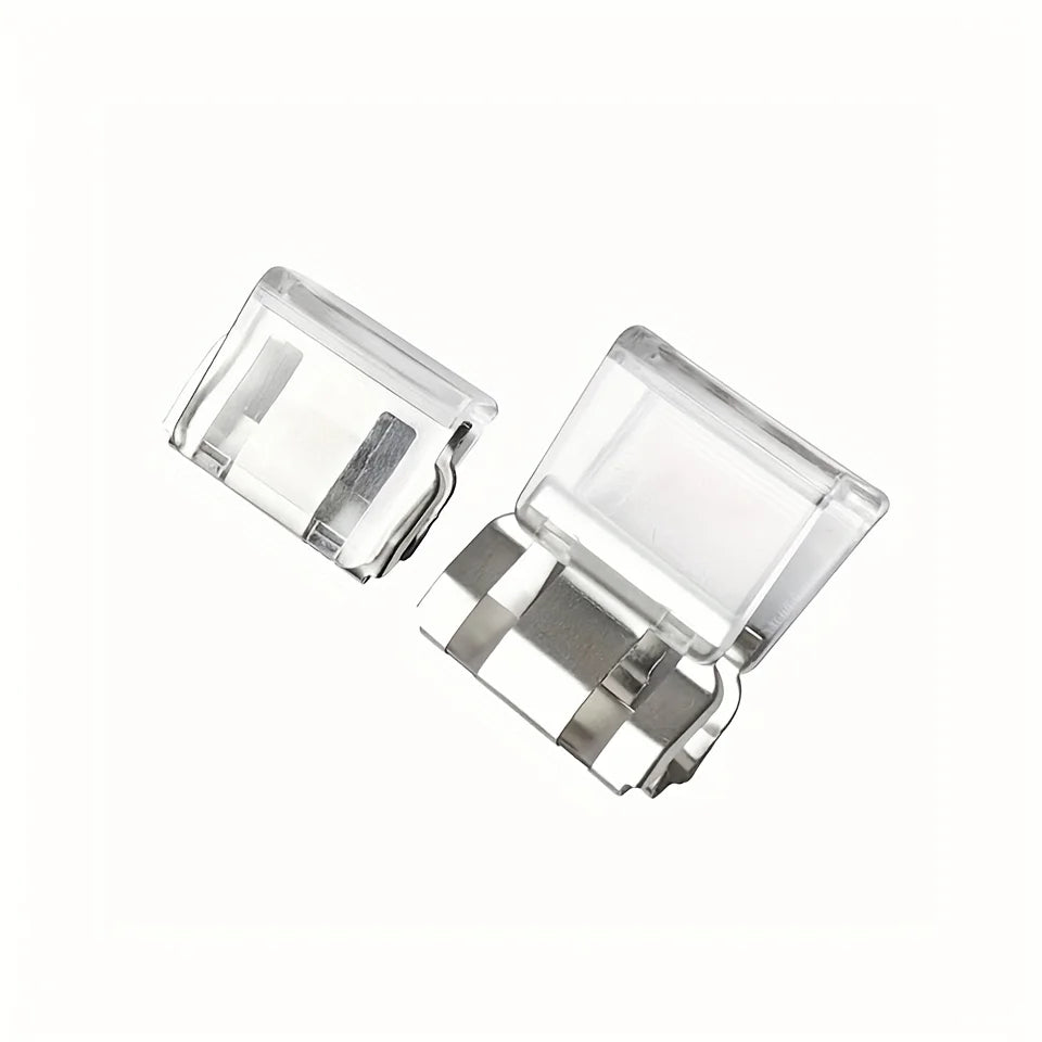 Clear plastic invisible pant hem clip with a silver metal component.
