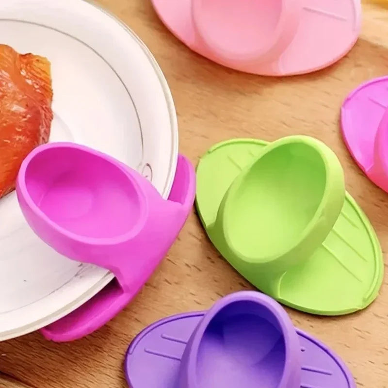 A collection of colorful silicone oven mitts and silicone spatulas are displayed on a wooden surface.