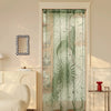 A sheer green lace door curtain featuring a sun and moon design hangs in a white frame.