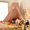 A pink princess hanging bed canopy with sheer fabric and fairy lights for a child's bedroom.