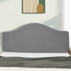 A gray soft elastic headboard cover is shown on a bed, with a light green wall and framed artwork in the background.