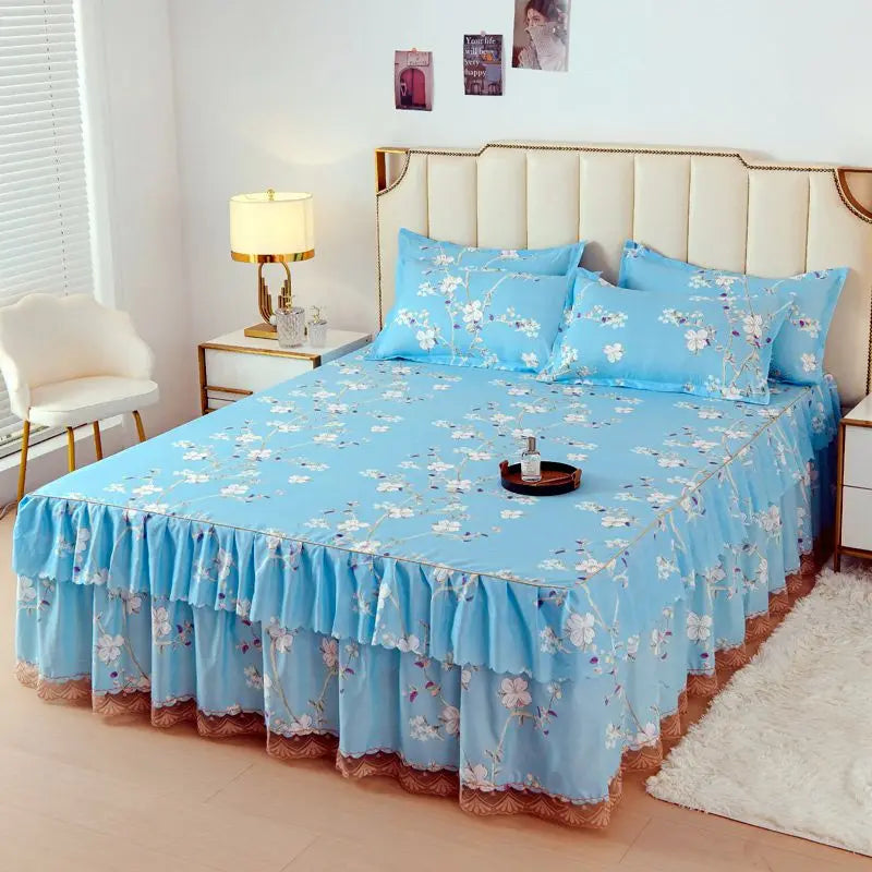 Light blue floral bed skirt with lace trim protecting a mattress on a bed.