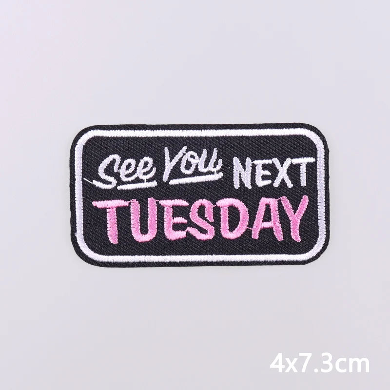 Black embroidery patch with pink text that reads See You Next Tuesday