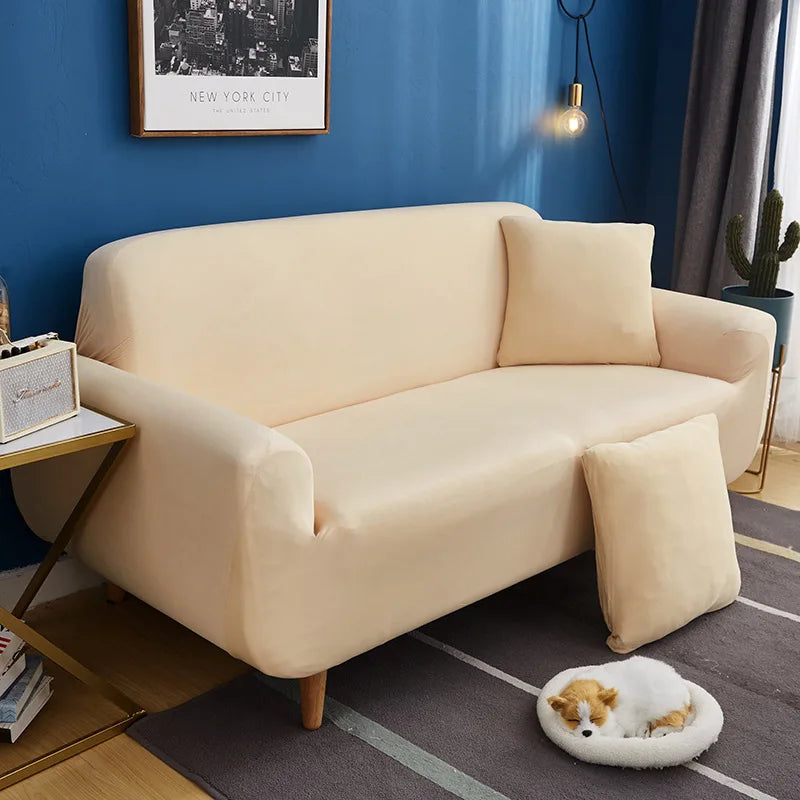 A beige universal stretch sofa and chair slipcover displayed in a modern living room setting.