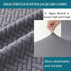 Close-up of gray high stretch knitted jacquard fabric showing a textured pattern and soft hand feel.