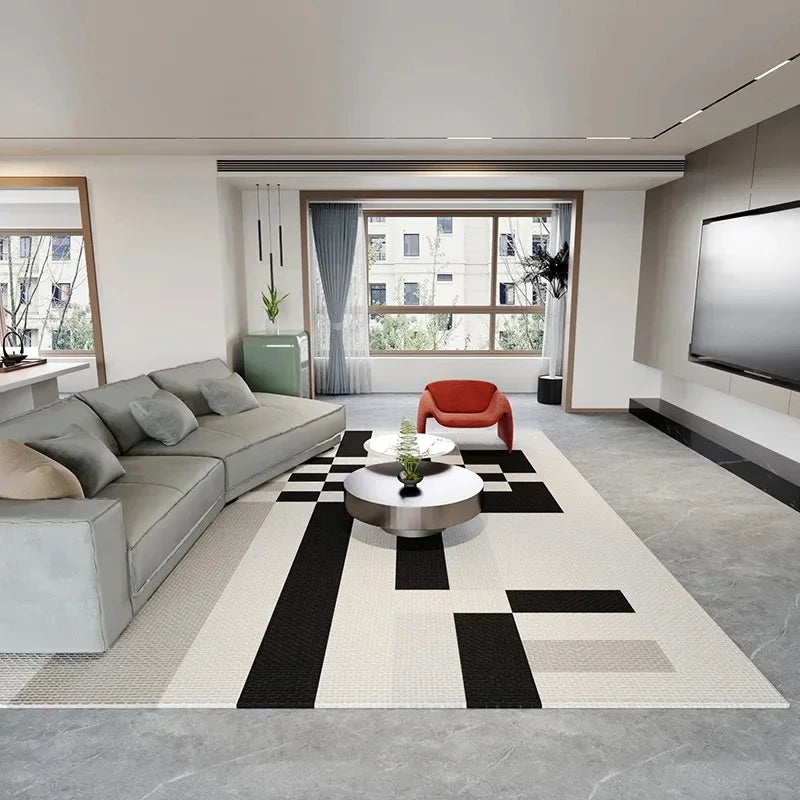 A rectangular area rug with a black and white geometric pattern is displayed in a modern living room setting.