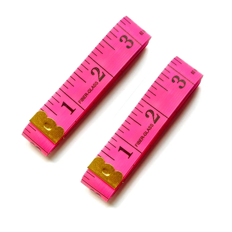 A set of two pink fiberglass measuring tapes showing markings up to 3 inches.