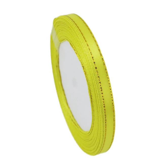 A roll of 6mm gold-edged satin ribbon in bright yellow for gift wrapping and crafts.