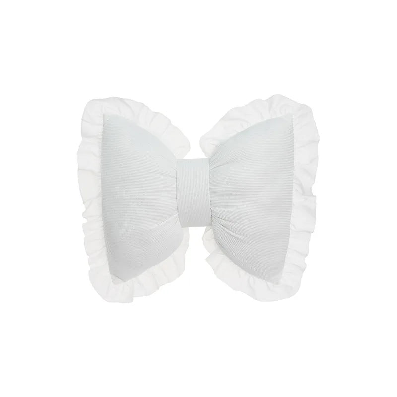 White elegant sofa cushion with lace trim and a bow detail