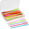 A clear plastic box filled with various colored plastic sewing needles for yarn crafting.