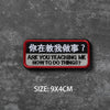 A black and red embroidered badge with Chinese and English text on a dark gray textured background.