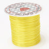A spool of yellow multicolor elastic beading cord with a circular label featuring stars and text.