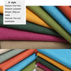 A stack of various colored coarse linen and cotton fabric rolls shown in close-up.