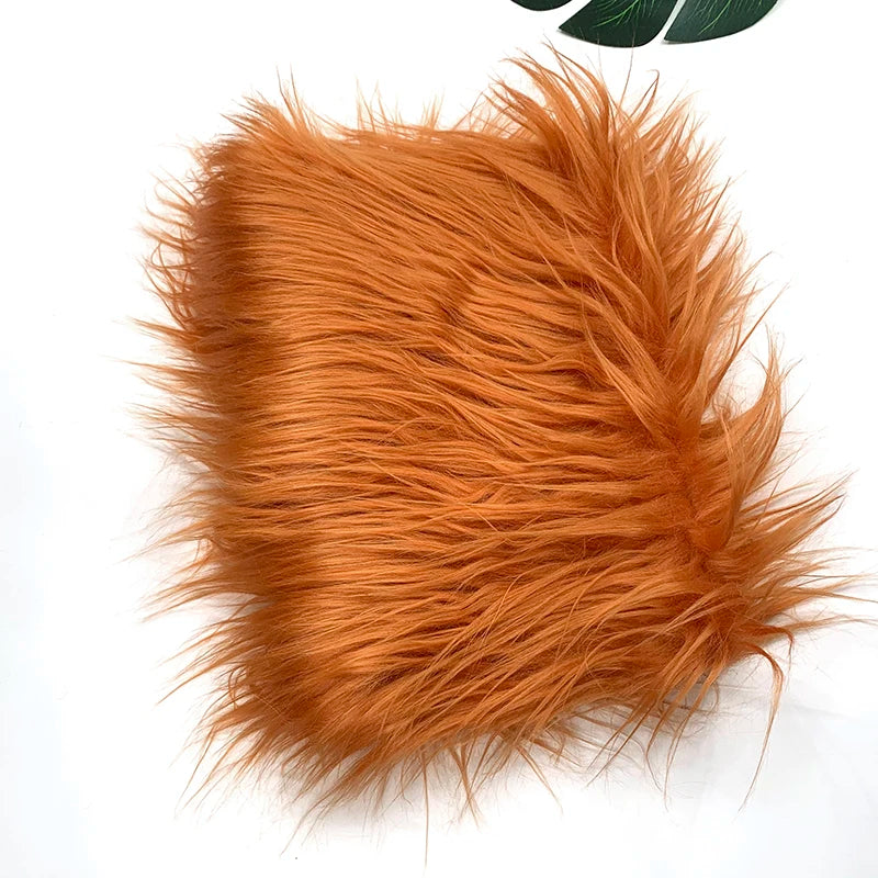 A fluffy orange faux fur fabric used for sewing and crafting.