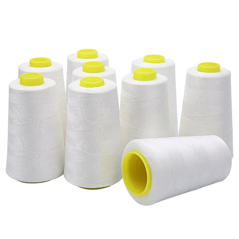 White spools of durable polyester sewing thread with yellow caps