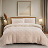 A beige boho tufted microfiber duvet cover set displayed on a bed with a framed landscape painting.