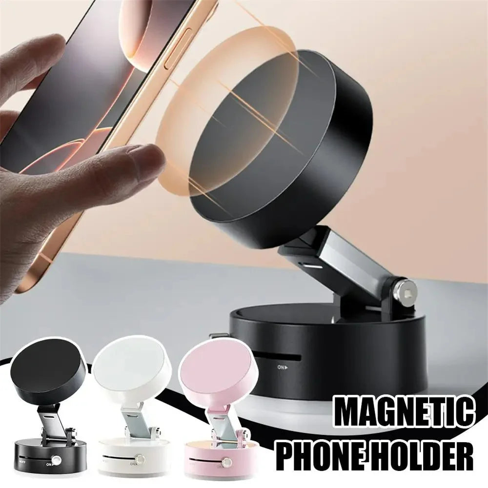 A hand holds a smartphone above a magnetic phone holder with a vacuum suction base, demonstrating the foldable magnetic phone
