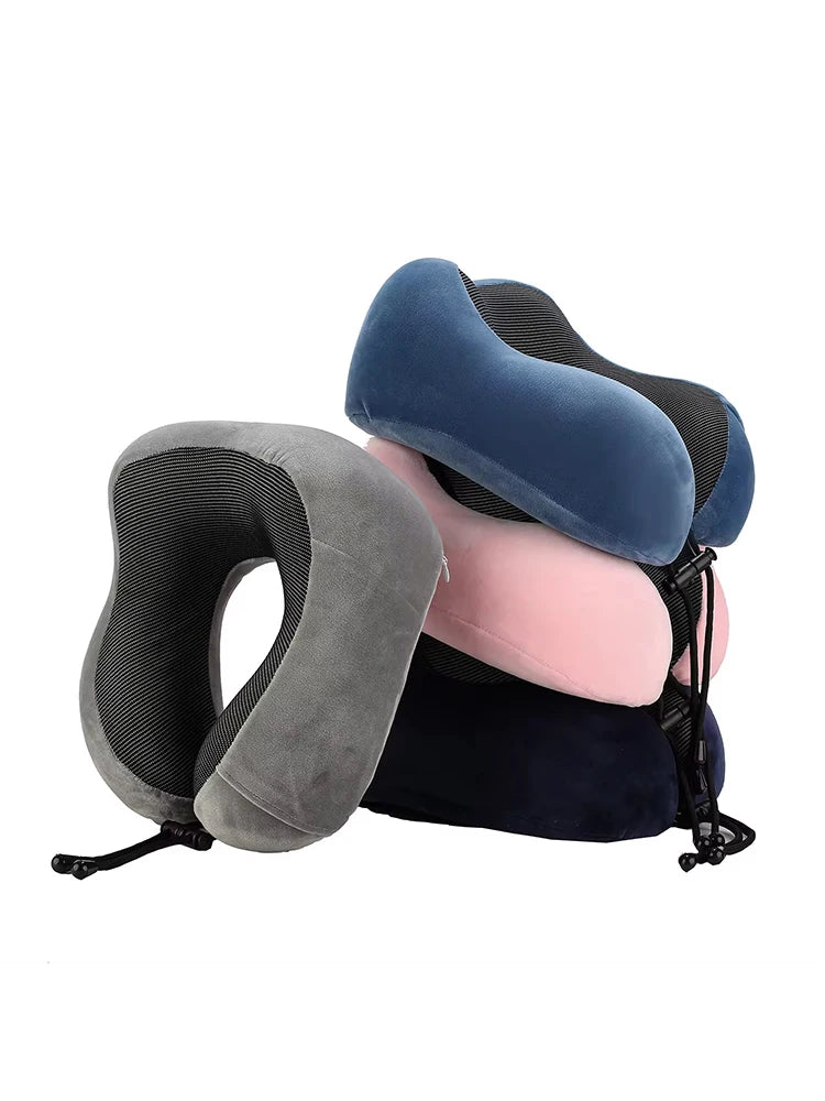 A stack of ergonomic memory foam neck pillows in shades of gray, blue, and pink.