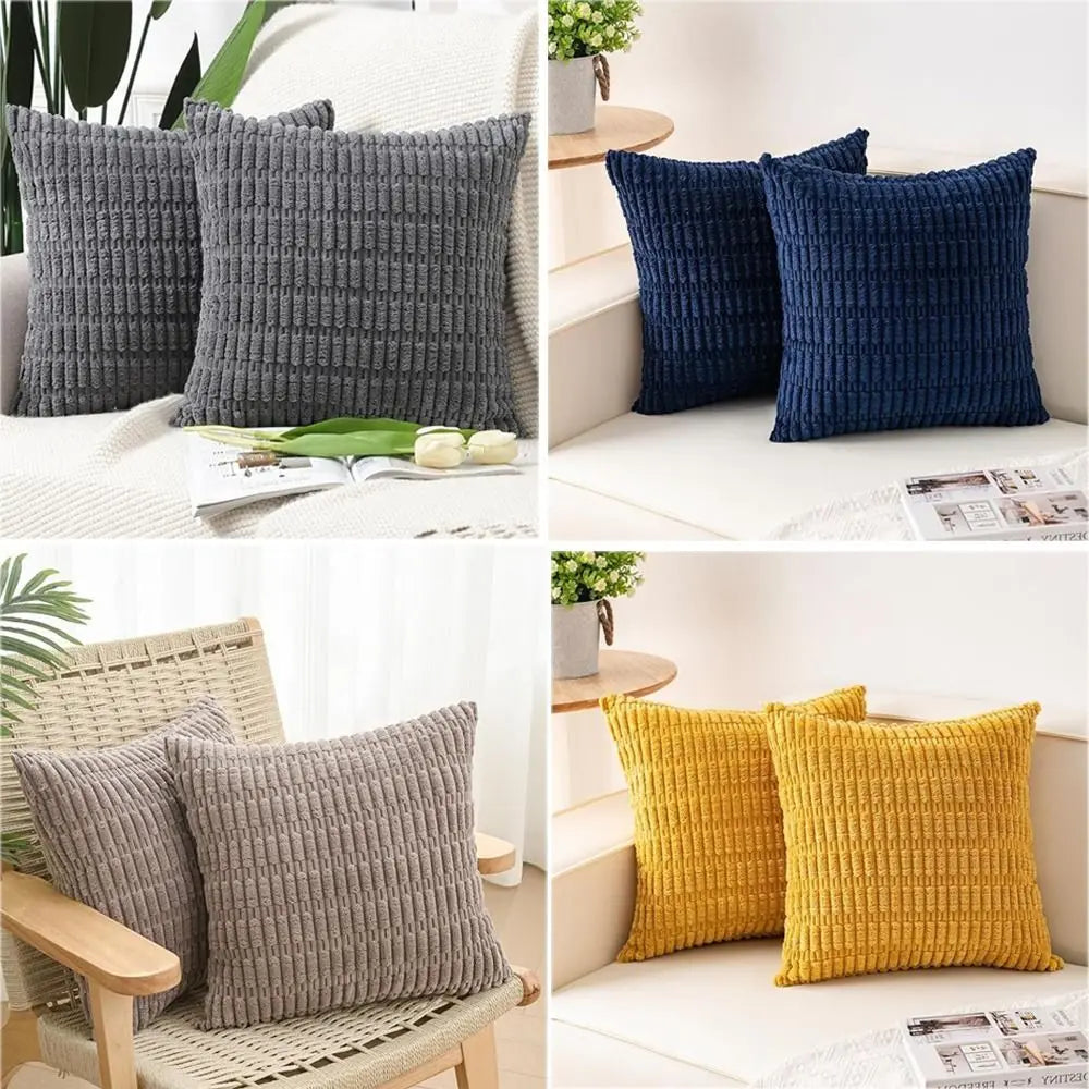 A set of two dark blue and gray knitted throw pillows displayed on a white surface.