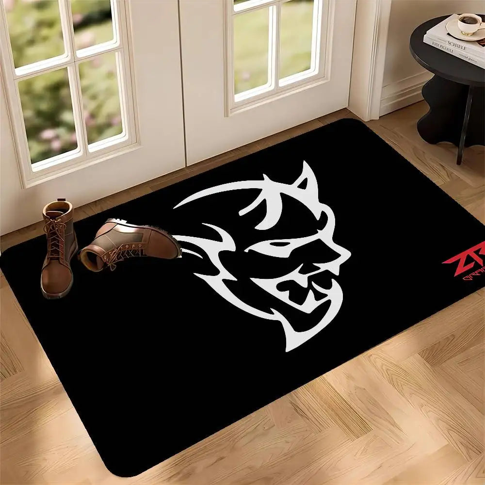 Black door mat featuring a white stylized animal head design on a light wood floor.