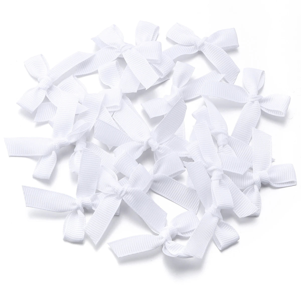 A pile of white satin ribbon bows for craft and decoration.