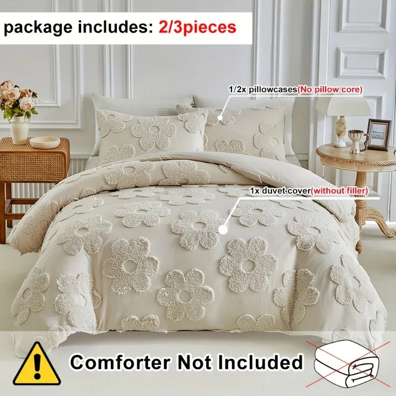 A set of white floral duvet cover and pillowcases with embossed detailing displayed on a bed.