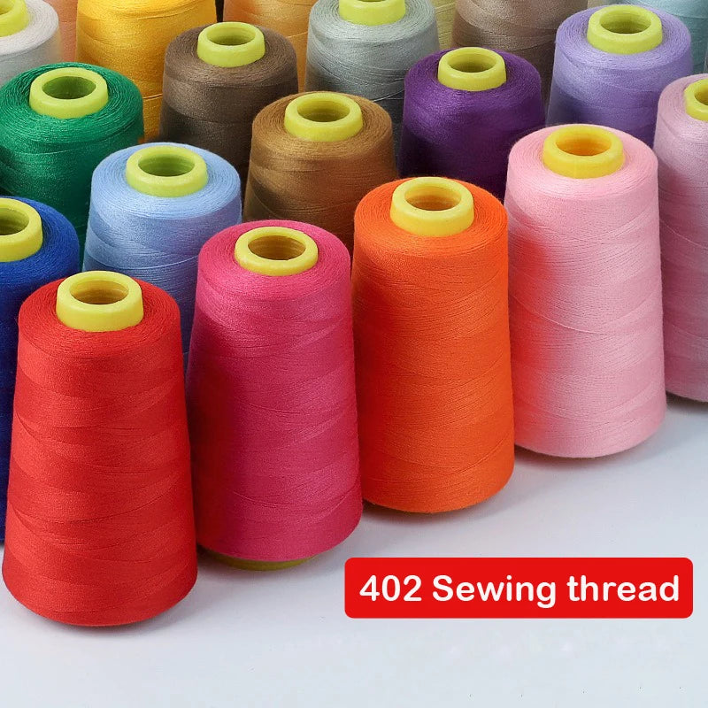 A collection of colorful sewing thread spools in various shades of green, yellow, brown, purple, and orange.