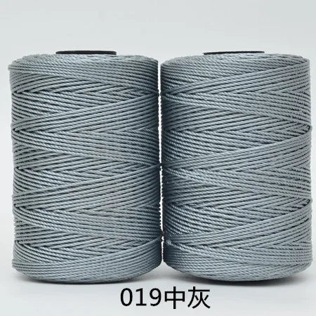 Two spools of gray hand knitting and crochet cord for crafting