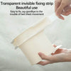 A hand is holding a transparent invisible fixing strip designed to secure bed sheets.