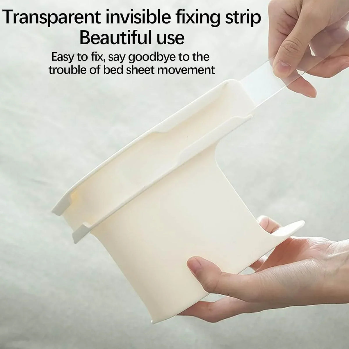 A hand is holding a transparent invisible fixing strip designed to secure bed sheets.
