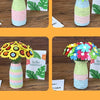 DIY felt flower craft kit bouquet featuring colorful flowers in striped ceramic vases and green leaves