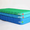 A stack of green and blue protective kneeling mats, with labels indicating others and ours.