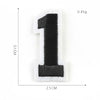 A black number one patch with white edges, measuring 5.1 cm by 2.5 cm and weighing 0.45g.