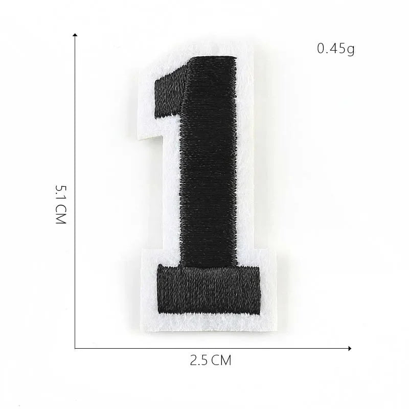 A black number one patch with white edges, measuring 5.1 cm by 2.5 cm and weighing 0.45g.