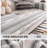 Gray striped anti-slip plush sofa cover draped over a sofa with decorative pillows.